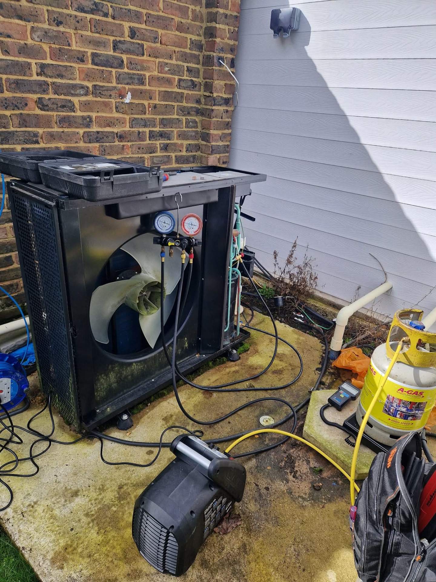 Swimming pool heat pump repair with refrigerant recovery equipment